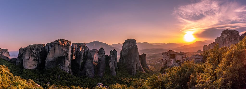 Golden Hour at Meteora: Witness the breathtaking beauty of the cliffside monasteries as the sun sets over the mystical landscape of Kalabaka, Greece.